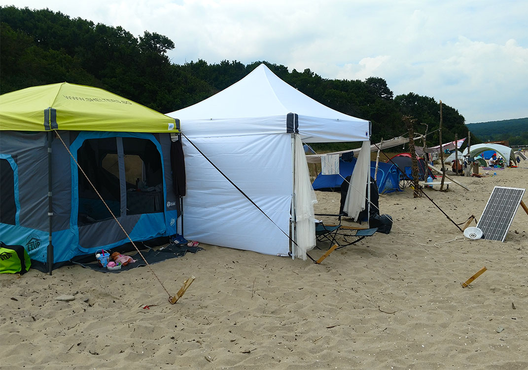 Къмпинг Куб и Бяла шатра E-Z UP® разпънати на плажа в Иракли